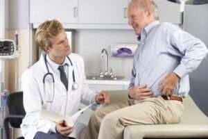 Doctor examining patient’s knee pain.