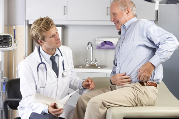 Doctor examining patient’s knee pain.