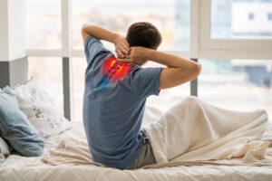 man suffering from neck pain