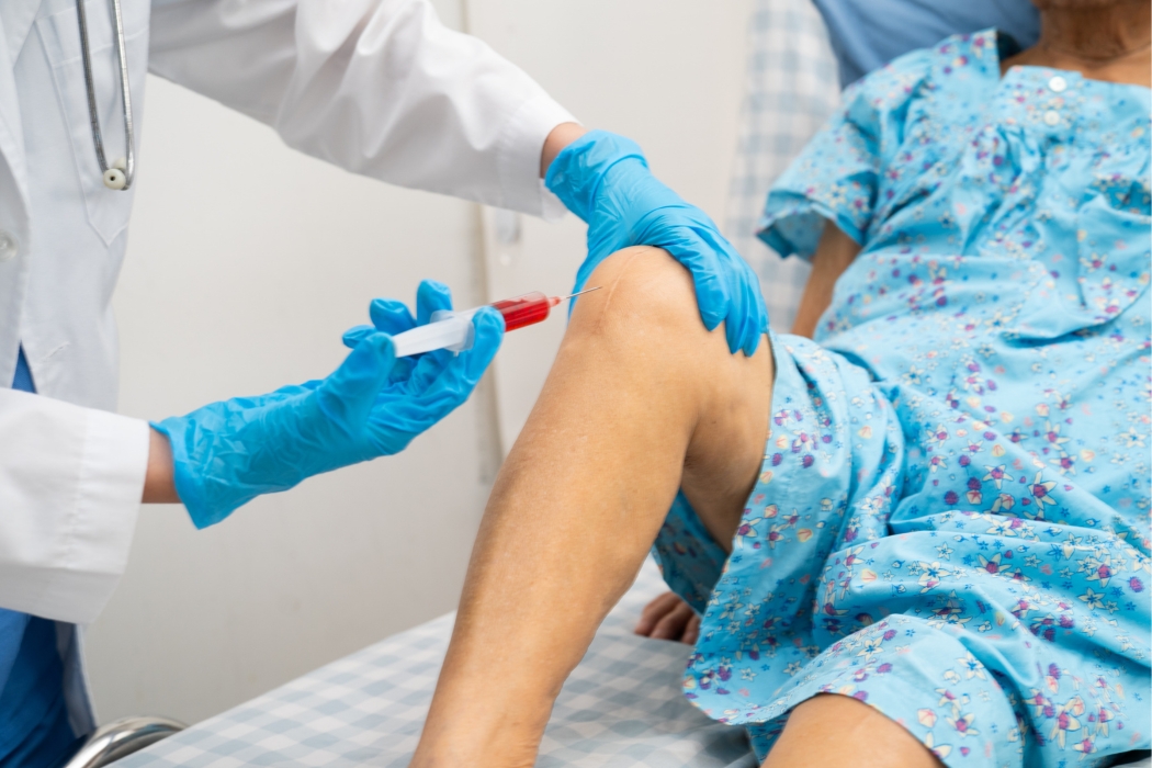 doctor inserting an injection