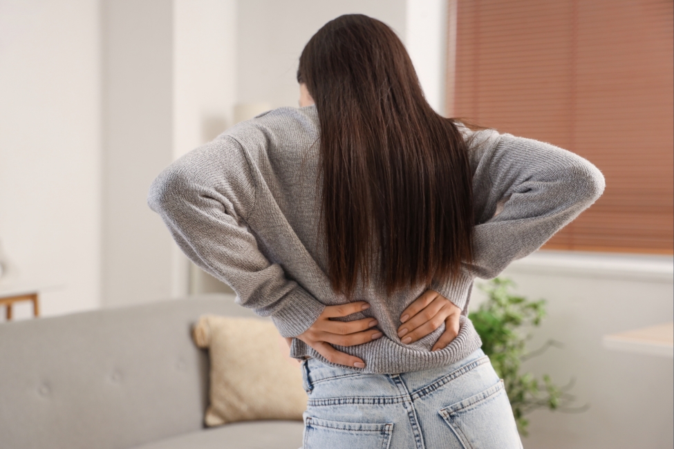 woman in back pain when standing